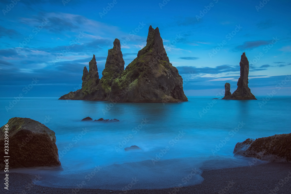 The Reynisdrangur - known rock needles in the Atlantic Ocean in southern Iceland after sunset The Reynisdrangur - known rock needles in the Atlantic Ocean in southern Iceland after sunset