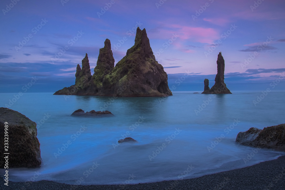 The Reynisdrangur - known rock needles in the Atlantic Ocean in southern Iceland after sunset