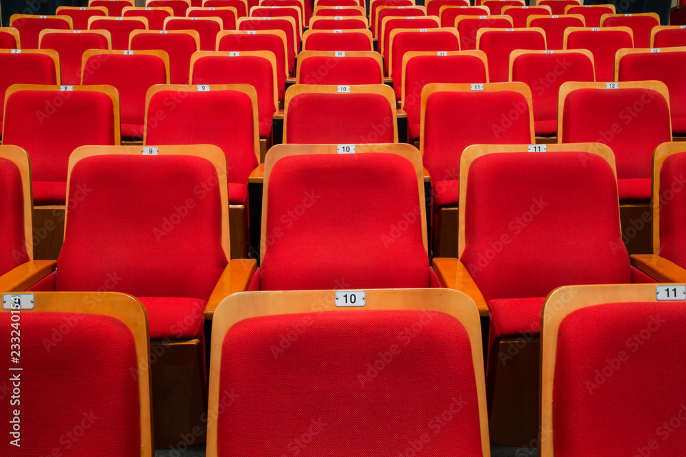 Fototapeta premium Red chairs in the auditorium of the theater or concert hall.