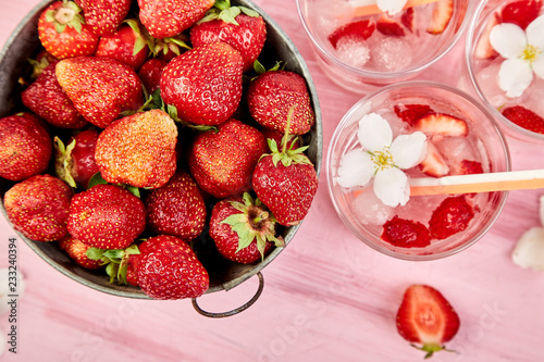 Strawberry detox water with jasmine flower. Summer iced drink or tea.