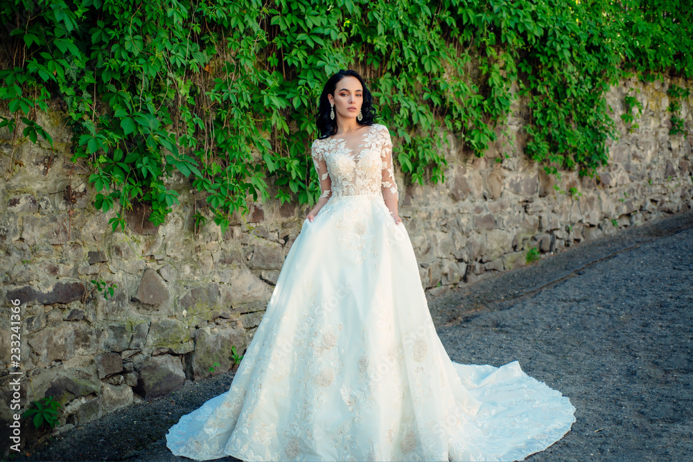 Wonderful bridal gown. Beautiful wedding dresses in boutique. Elegant wedding salon is waiting for bride. woman is preparing for wedding. Happy bride before wedding. Extremely happy