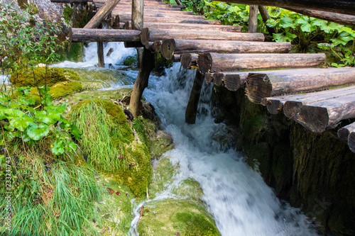 a creek under a wooden bridge