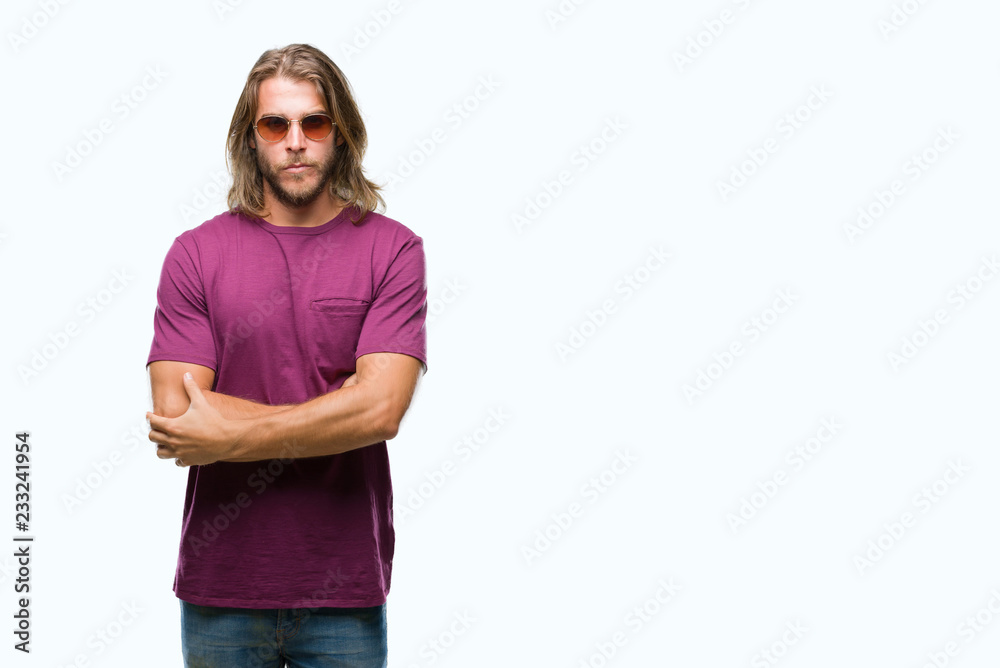 Fototapeta premium Young handsome man with long hair wearing sunglasses over isolated background skeptic and nervous, disapproving expression on face with crossed arms. Negative person.