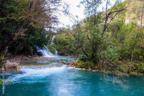 turquoise pond with waterfall