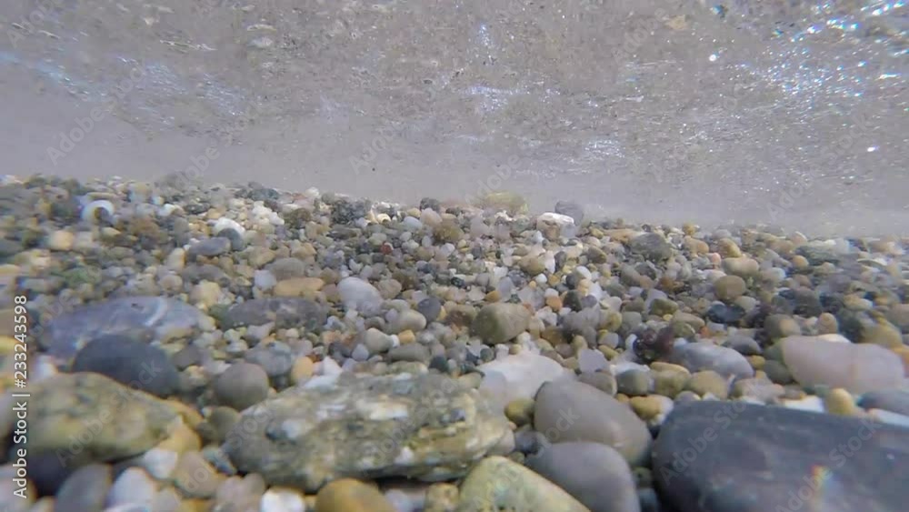 Stones under water with waves of the sea