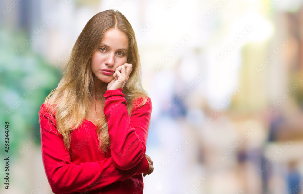 Young beautiful blonde woman wearing red sweater over isolated background thinking looking tired and bored with depression problems with crossed arms.