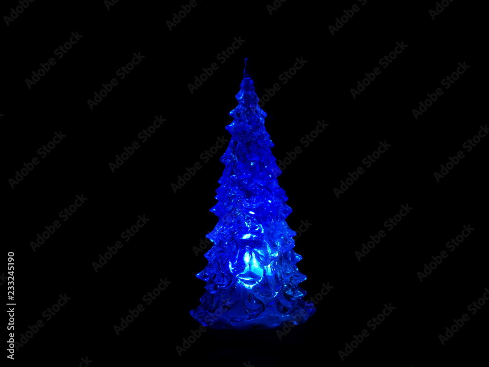 Christmas tree glowing in the black background Christmas tree glowing in the black background