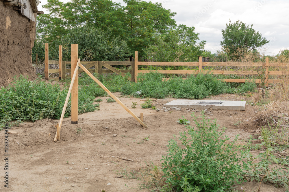 The Foundation for mount wooden fence. Foundation for the fixing the rural fence in the ground.