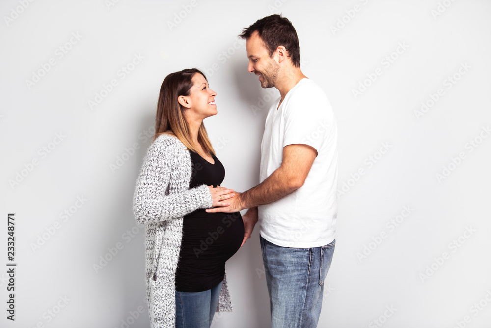 A Pregnant woman with man on studio isolated on white A Pregnant woman with man on studio isolated on white