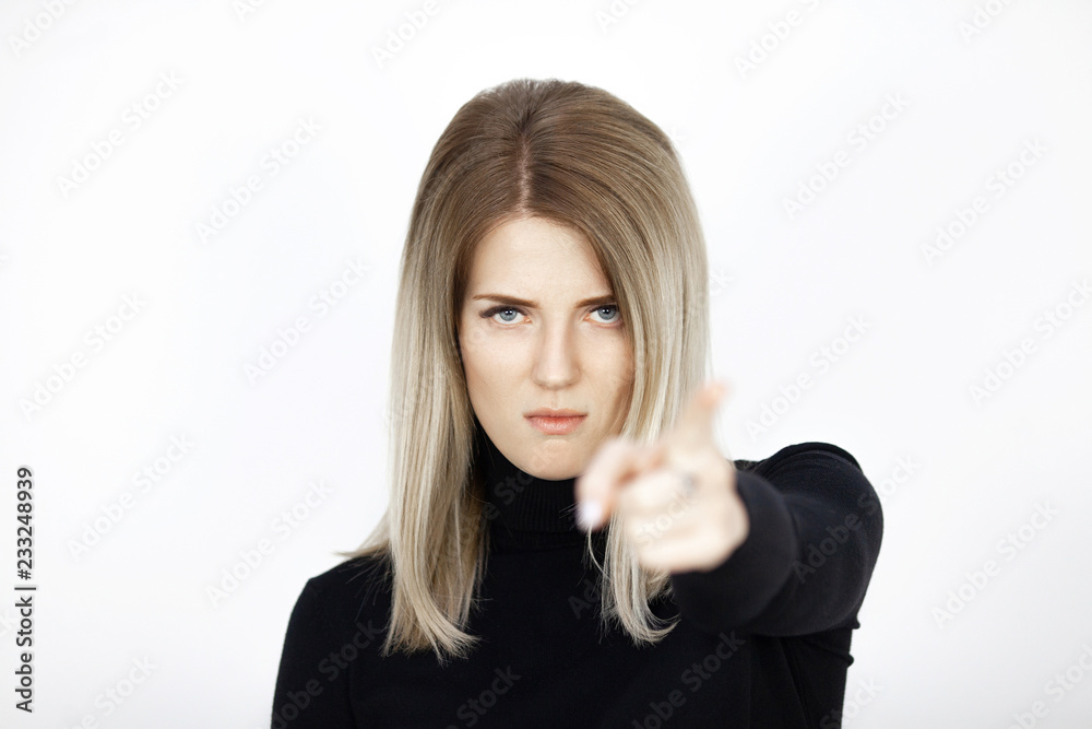 Young attractive blonde woman shows finger into camera with conviction Young attractive blonde woman shows finger into camera with conviction