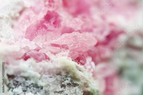 Pink crystals Rhodochrosite with particles of Pyrite. Natural texture of mineral for background. Beautiful background and wallpaper. Macro.