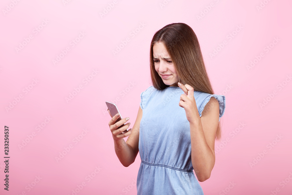 Beautiful girl with smartphone on pink background Beautiful girl with smartphone on pink background
