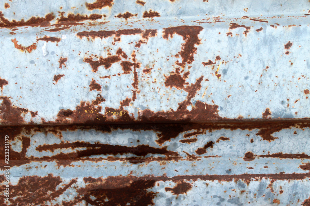 Multicolored background: rusty metal surface with blue paint flaking and cracking texture Multicolored background: rusty metal surface with blue paint flaking and cracking texture