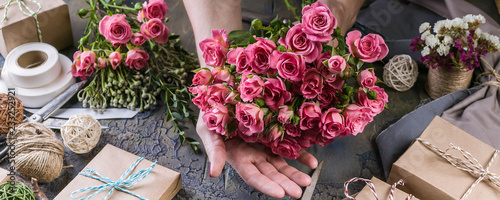 Web banner. Small business concept. Work process of florist. Female hands making wedding bouquet on a dark table