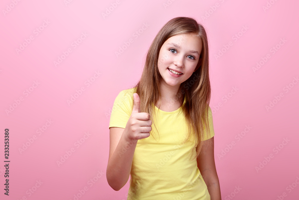 Cute young girl on pink background Cute young girl on pink background