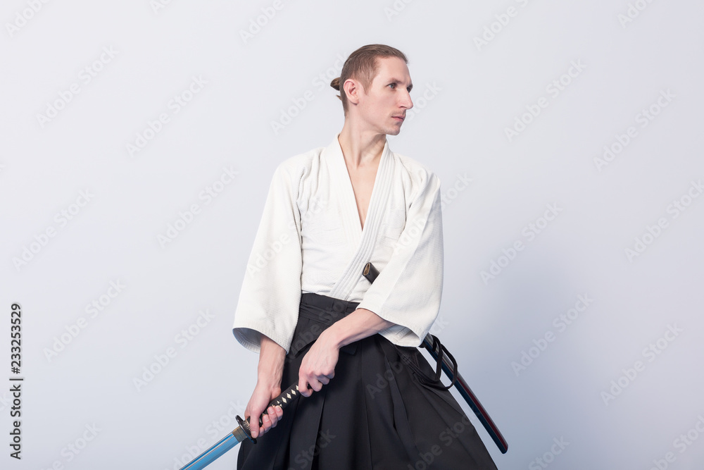 A man with katana on Iaido practice. Selective focus A man with katana on Iaido practice. Selective focus