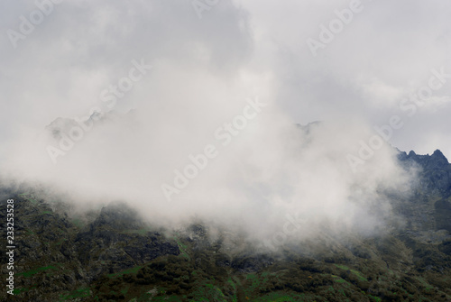 background - the clouds cover the mountain slope in the highlands