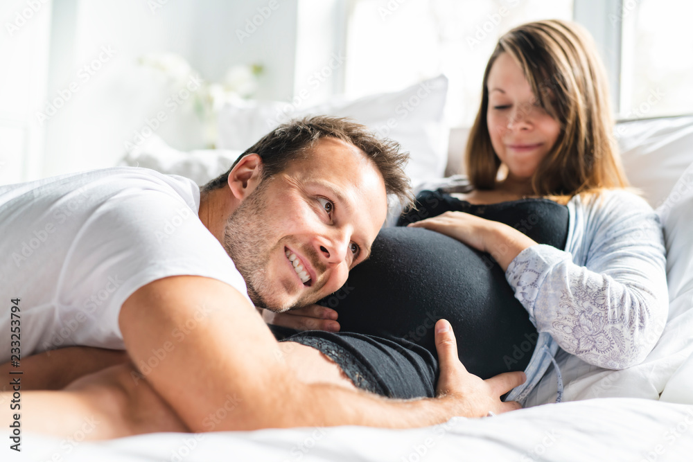 A parents in bed expecting a little baby, Romantic moments for pregnant couple