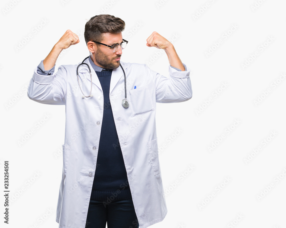 Young handsome doctor man over isolated background showing arms muscles smiling proud. Fitness concept. Young handsome doctor man over isolated background showing arms muscles smiling proud. Fitness concept.
