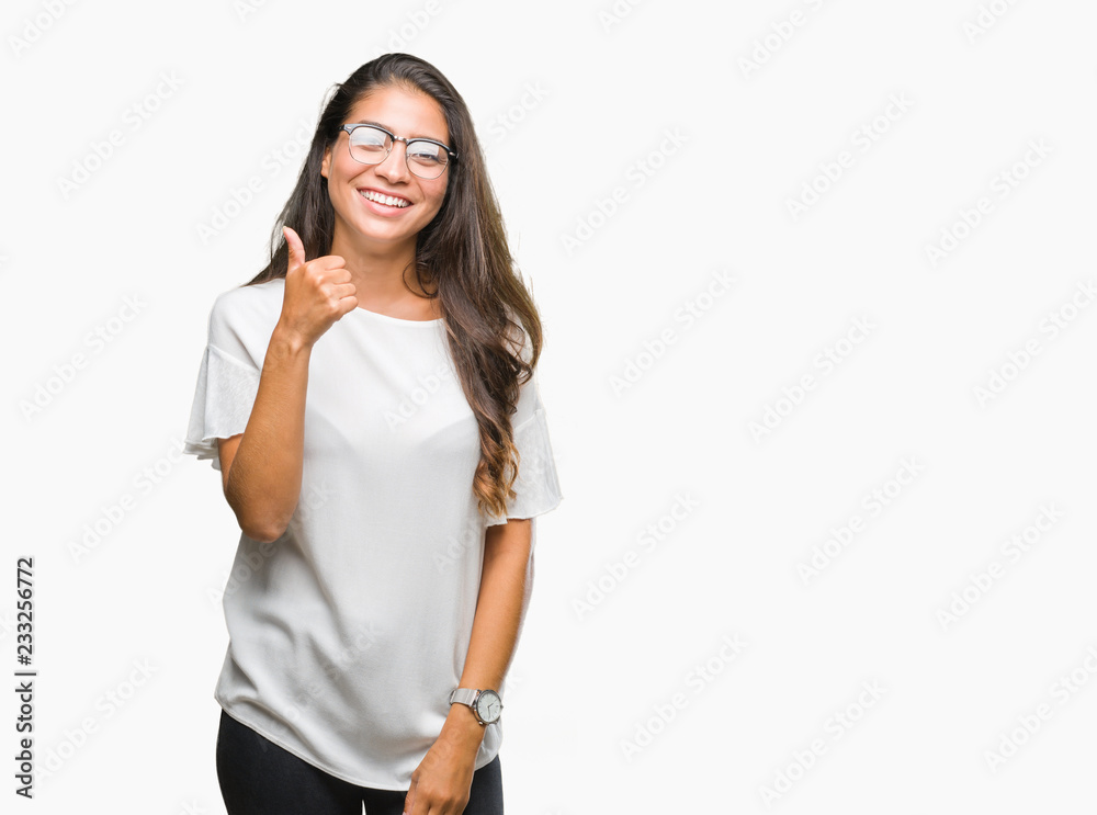 Young beautiful arab woman wearing glasses over isolated background doing happy thumbs up gesture with hand. Approving expression looking at the camera with showing success. Young beautiful arab woman wearing glasses over isolated background doing happy thumbs up gesture with hand. Approving expression looking at the camera with showing success.
