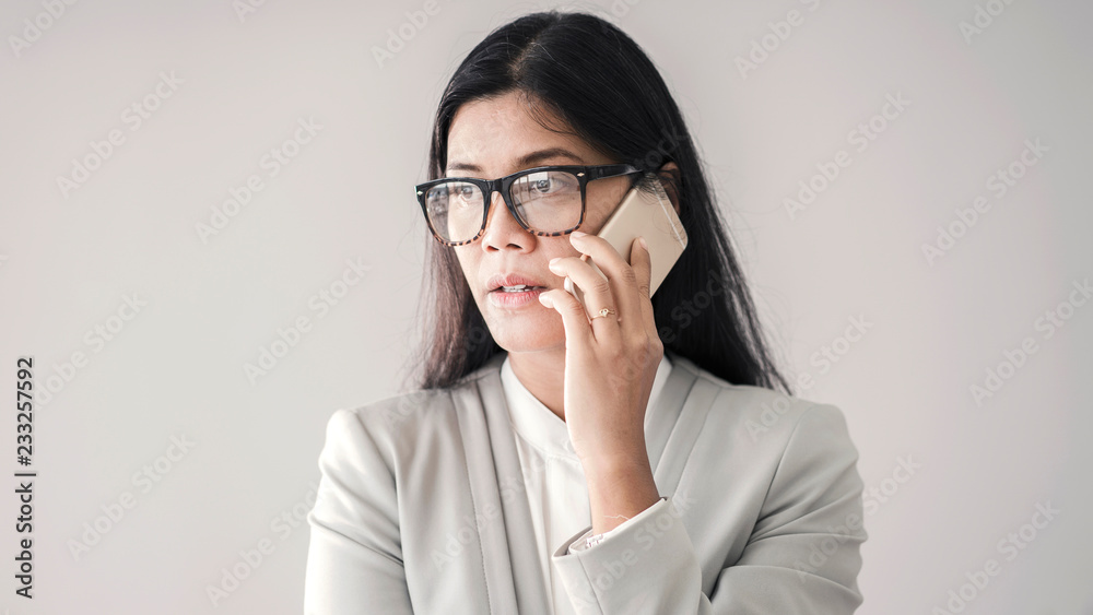Asian woman talking mobile phone Asian woman talking mobile phone