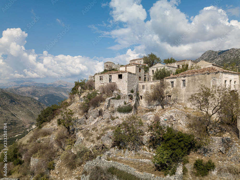 Photo of abandoned Albanian buildings in the village of Upper Qeparo, Albania