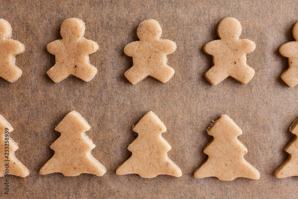 Homemade Christmas gingerbread. Raw dough. Bells, little men, horses, Christmas trees. Winter background