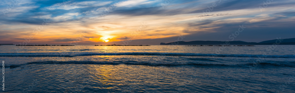 Obraz premium Panoramic view of Alghero shore at sunset
