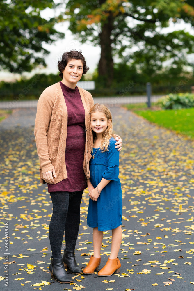 Mother and daughter posing outdoors Mother and daughter posing outdoors