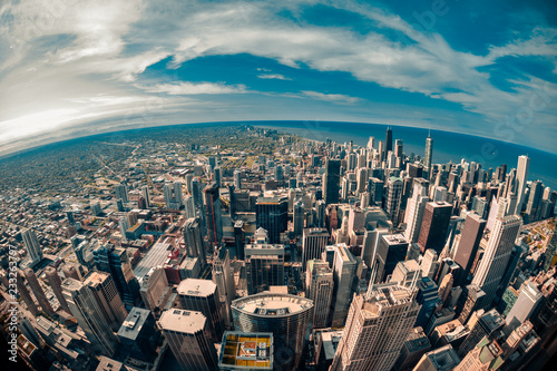 Fisheye aerial view looking down at the sprawling metropolis of Chicago Illinois with Lake Michigan in the background
