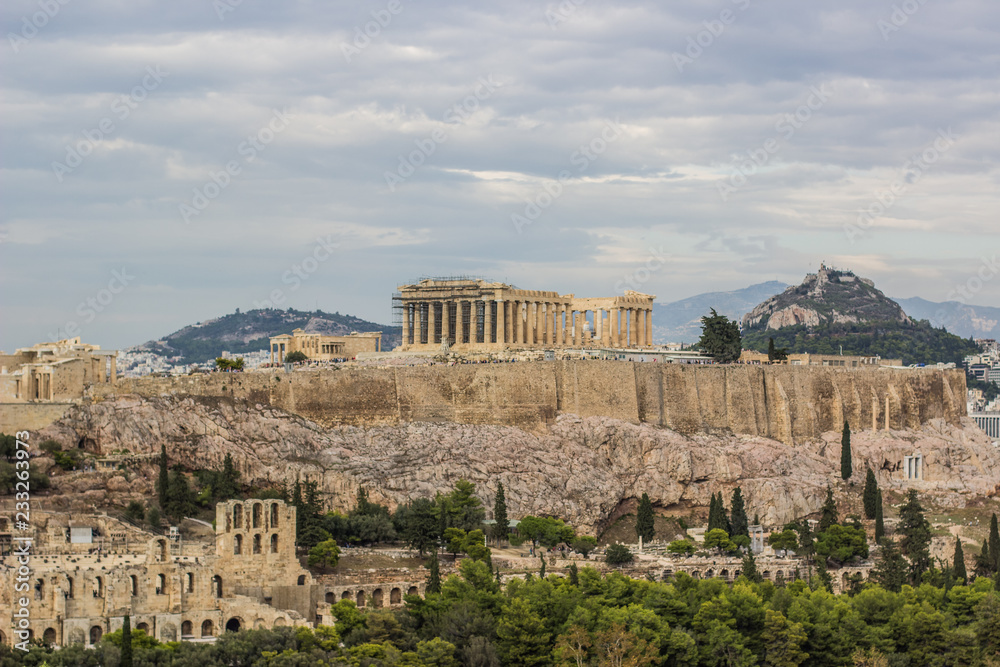 Ancient temple Parthenon in ruins of Acropolis on rock surrounded Athens - capital of Greece landmark