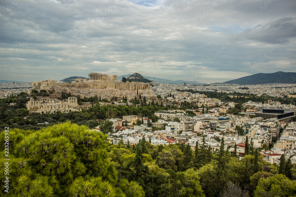 Ancient temple Parthenon in ruins of Acropolis on rock surrounded Athens - capital of Greece landmark