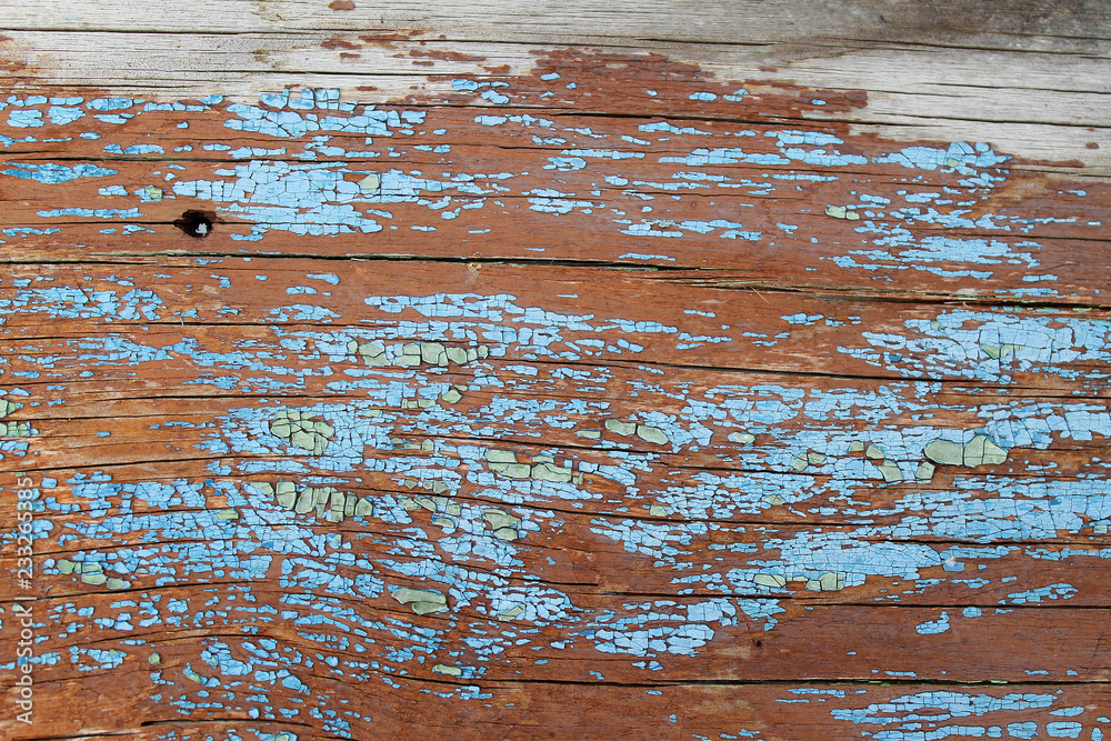 Old wooden background with remains of pieces of scraps of old paint on wood. Texture of an old tree, board with paint, vintage background peeling paint. old blue board with cracked pain Old wooden background with remains of pieces of scraps of old paint on wood. Texture of an old tree, board with paint, vintage background peeling paint. old blue board with cracked pain