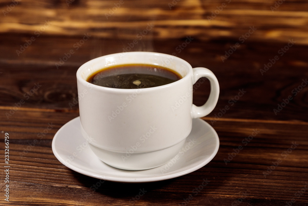 Cup of coffee on the wooden table
