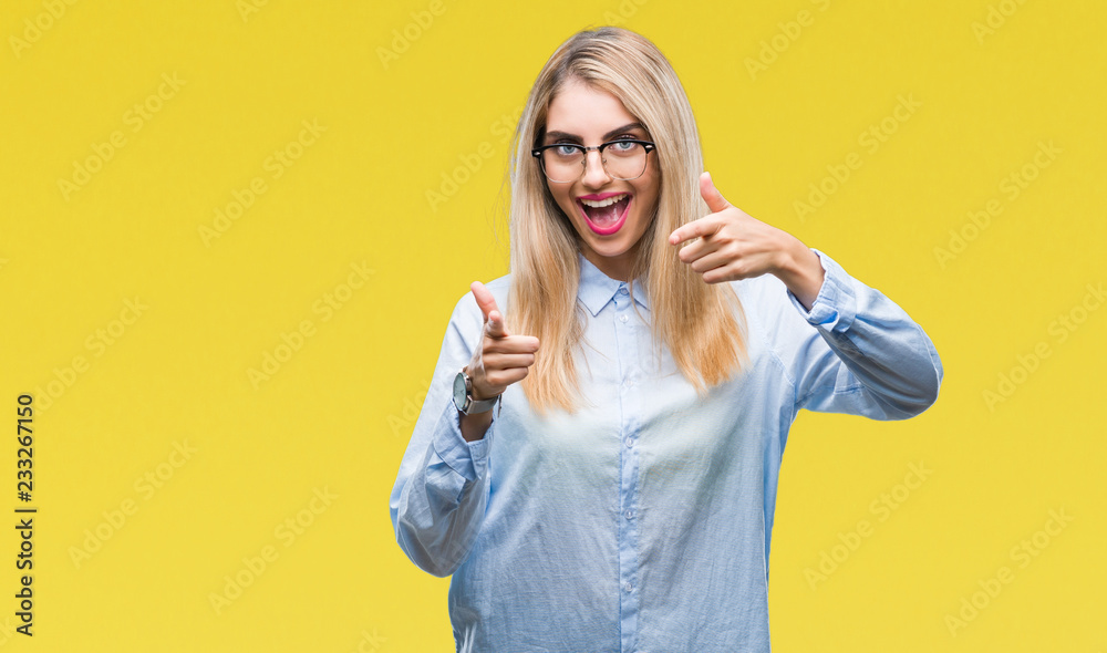 Young beautiful blonde business woman wearing glasses over isolated background pointing fingers to camera with happy and funny face. Good energy and vibes.