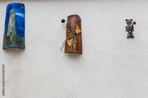 Artistic decorations hung on the wall, Villetta Barrea, Abruzzo, Italy. October 13, 2017 photo