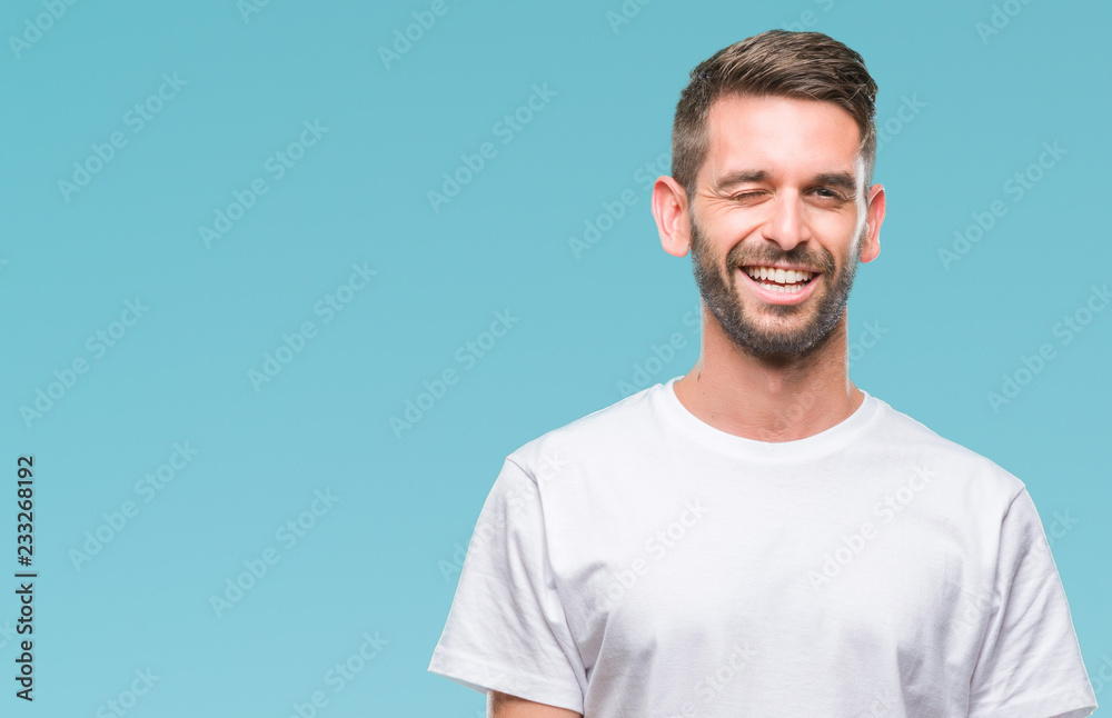 Young handsome man over isolated background winking looking at the camera with sexy expression, cheerful and happy face. Young handsome man over isolated background winking looking at the camera with sexy expression, cheerful and happy face.