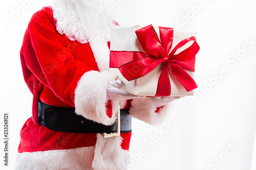 Santa holding a Christmas gift isolated on white background