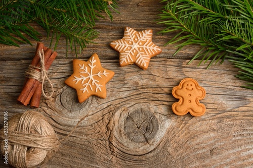 Fototapeta Naklejka Na Ścianę i Meble -  Gingerbread cookies. Christmas cookies on wooden background. Christmas decorations, gingerbread cookie dough,  and fir tree frame