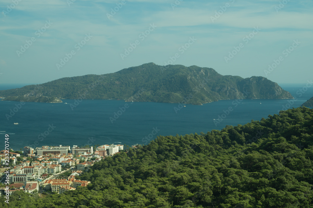 Mountain town panoramic view. city between the hills with the sea