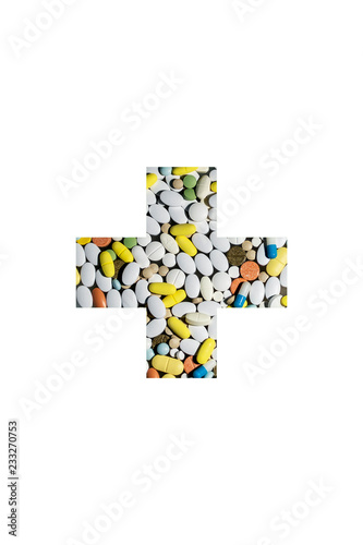 colored pills for treatment of diseases in the form of a medical cross photo