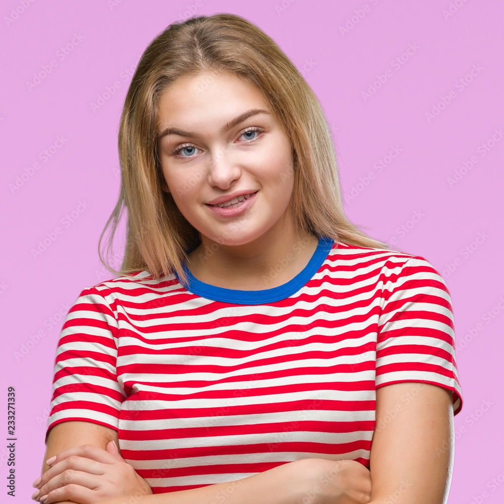 Young caucasian woman over isolated background happy face smiling with crossed arms looking at the camera. Positive person.