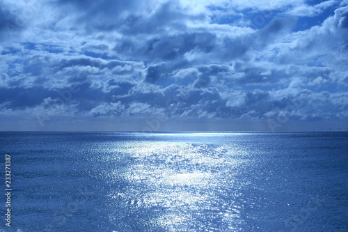 Canvas Print sea and sky lit by moonlight the sea is shimmering deep blue in the bottom half