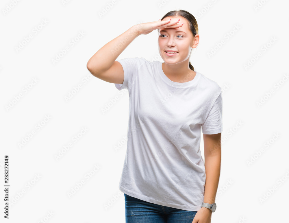 Young beautiful caucasian woman over isolated background very happy and smiling looking far away with hand over head. Searching concept. Young beautiful caucasian woman over isolated background very happy and smiling looking far away with hand over head. Searching concept.