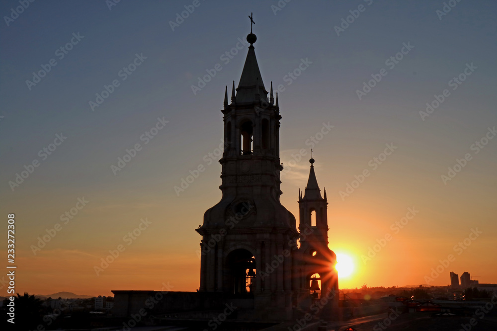 Impressive view of the setting sun shining through the belfry of Cathedral of Arequipa, Arequipa, Peru 