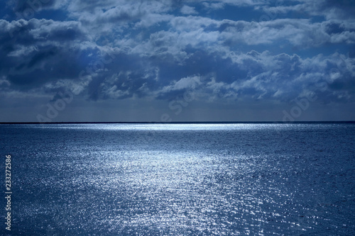 Tela sea and sky with shimmering ocean lit by moonlight