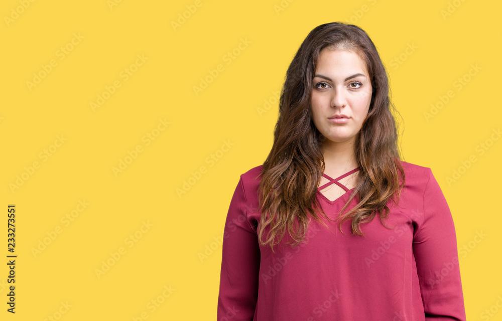 Beautiful plus size young woman over isolated background with serious expression on face. Simple and natural looking at the camera. Beautiful plus size young woman over isolated background with serious expression on face. Simple and natural looking at the camera.