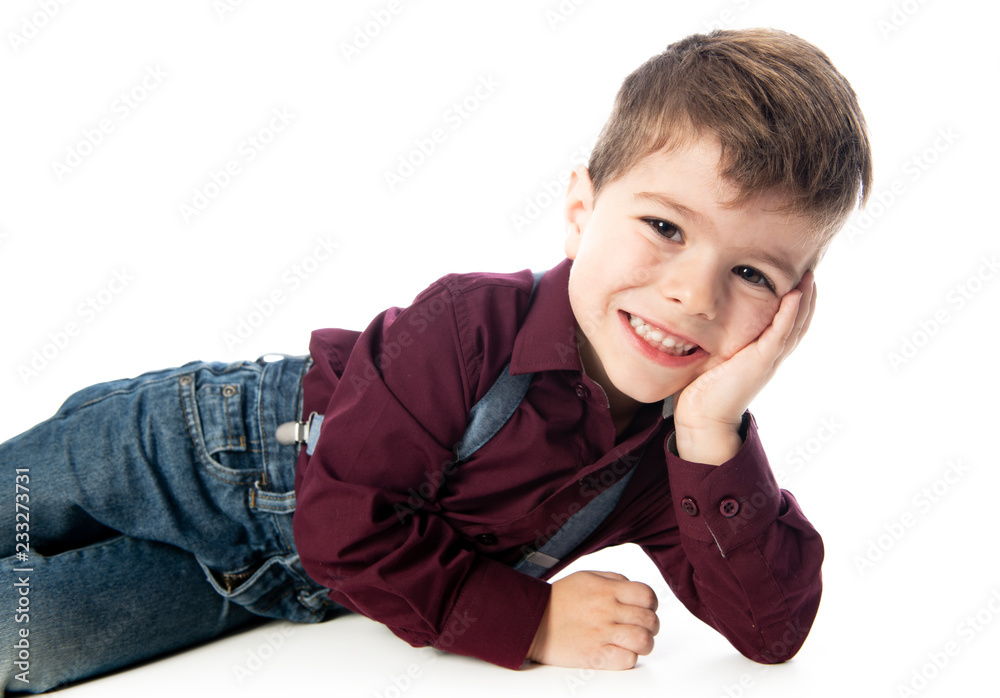 A four year old boy posing over white studio background A four year old boy posing over white studio background