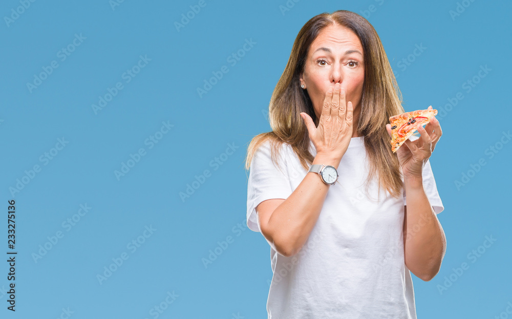 Middle age hispanic woman eating pizza slice over isolated background cover mouth with hand shocked with shame for mistake, expression of fear, scared in silence, secret concept Middle age hispanic woman eating pizza slice over isolated background cover mouth with hand shocked with shame for mistake, expression of fear, scared in silence, secret concept