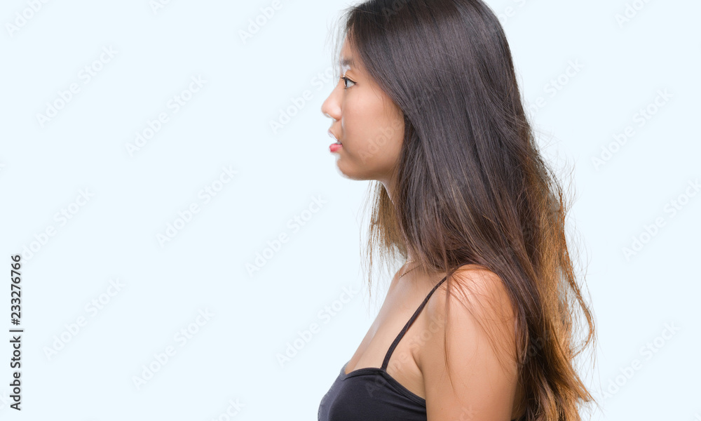 Young asian woman over isolated background looking to side, relax profile pose with natural face with confident smile. Young asian woman over isolated background looking to side, relax profile pose with natural face with confident smile.